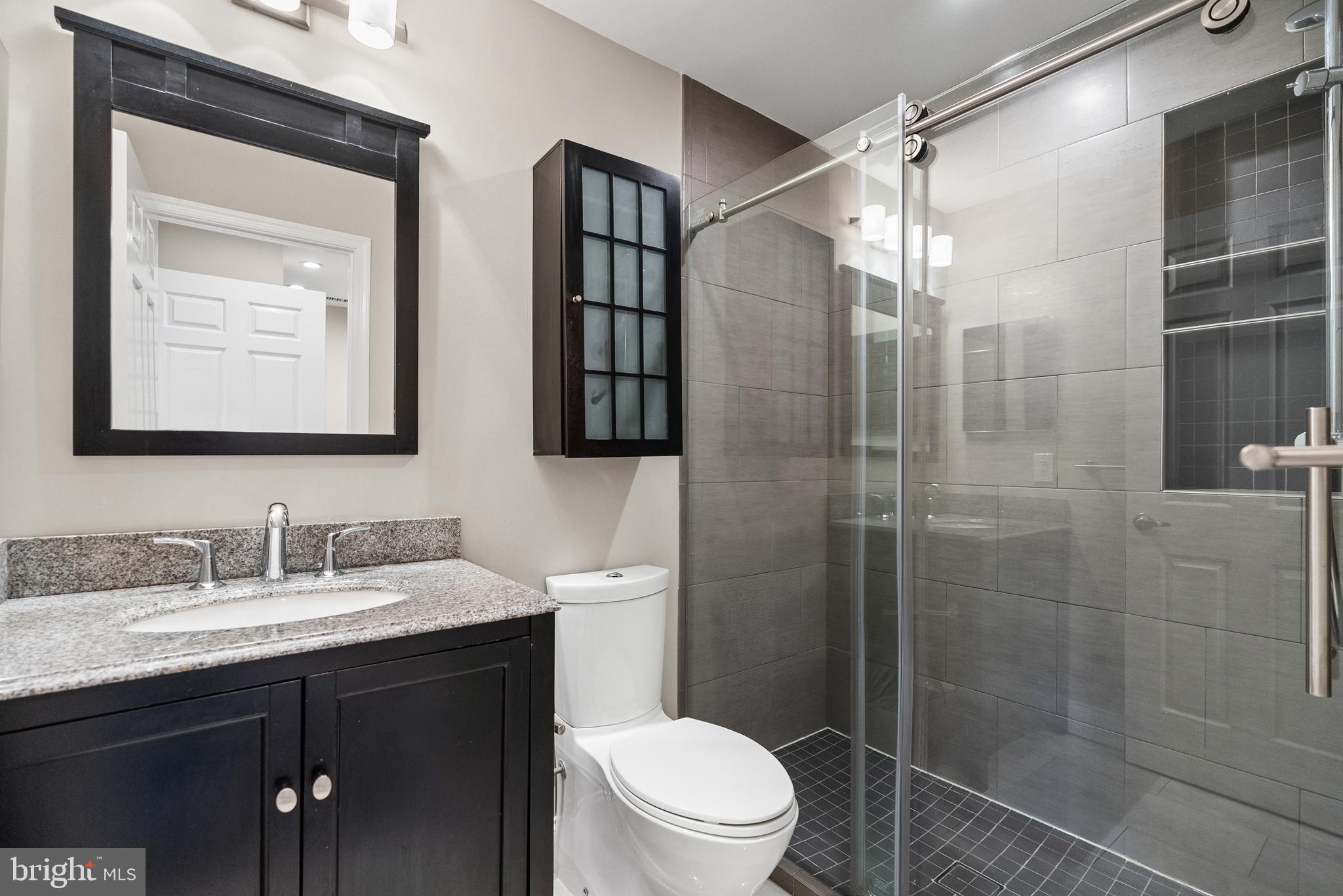 2011 Hillyer Place Northwest Washington, DC 20009 - Photo 19 of 21 a bathroom with a double vanity sink toilet and shower