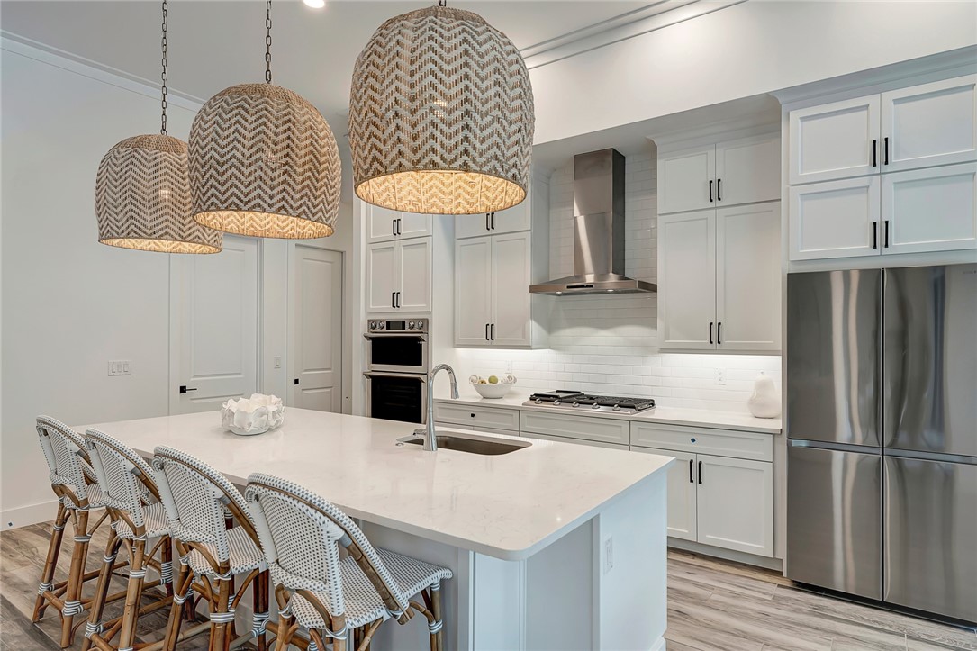 325 Holly Road Vero Beach, FL 32963 - Photo 13 of 25 a kitchen with stainless steel appliances granite countertop a sink a stove a refrigerator and island