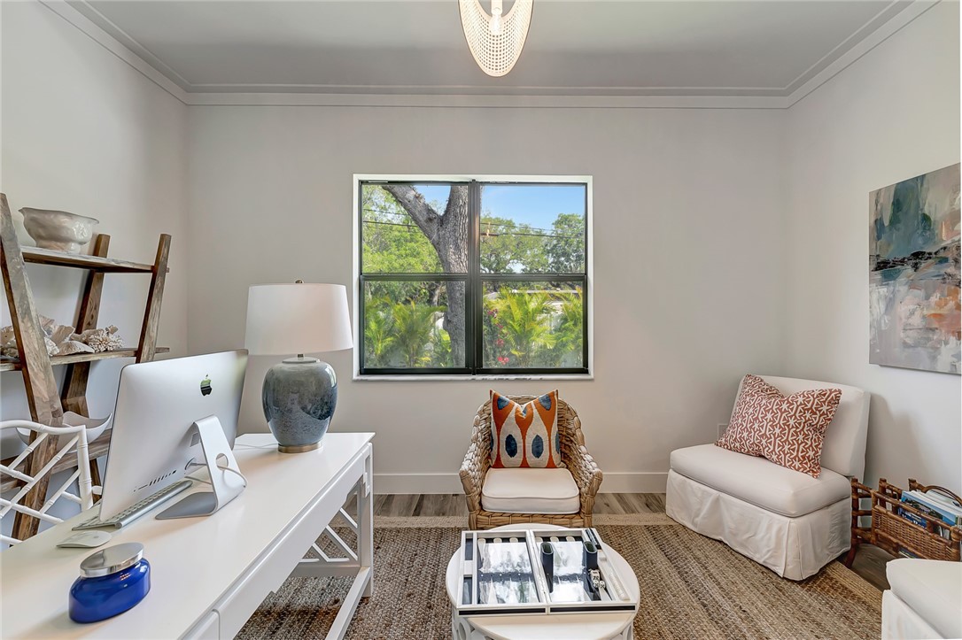 325 Holly Road Vero Beach, FL 32963 - Photo 14 of 25 a living room with furniture a rug and a large window