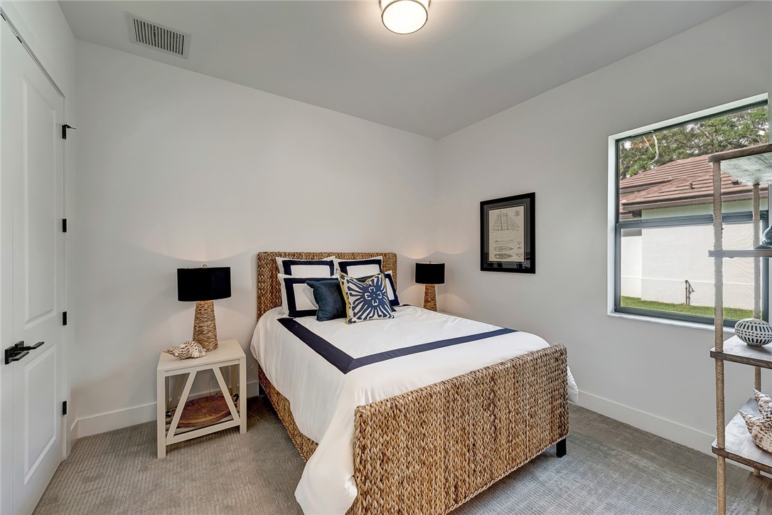325 Holly Road Vero Beach, FL 32963 - Photo 19 of 25 a bedroom with a bed and a window