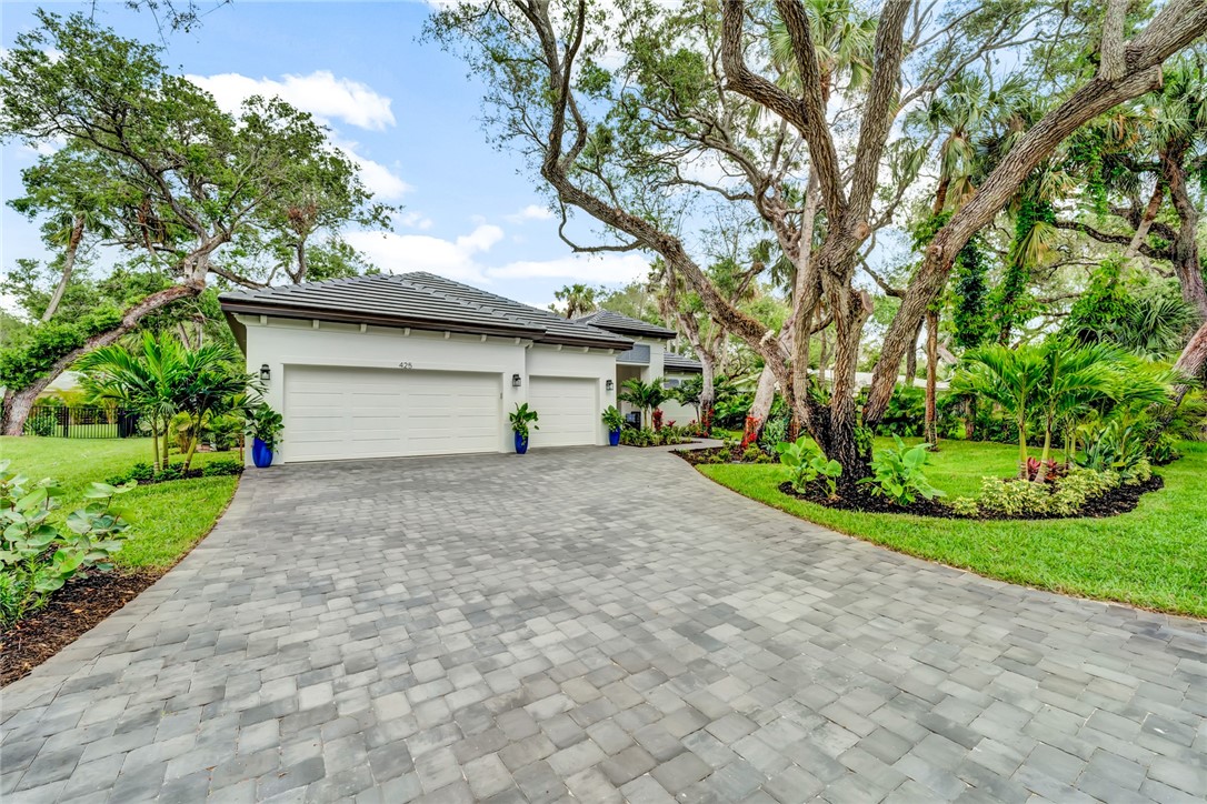325 Holly Road Vero Beach, FL 32963 - Photo 2 of 25 a view of a house with a yard and garage