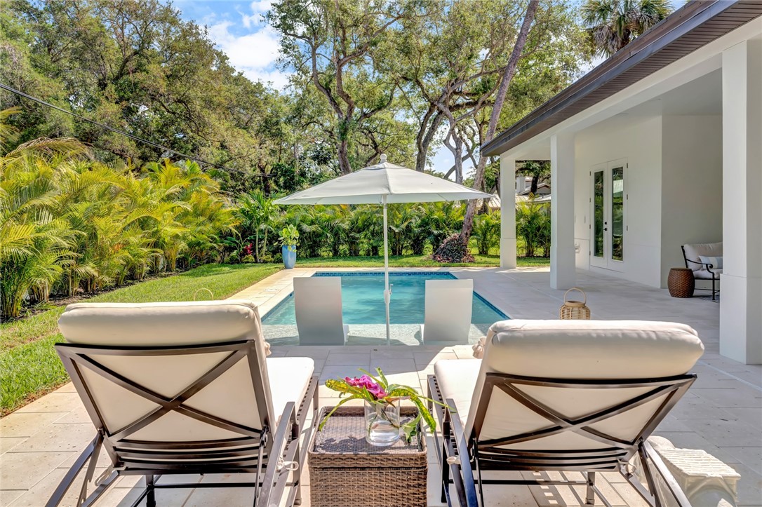 325 Holly Road Vero Beach, FL 32963 - Photo 25 of 25 a view of a patio with table and chairs and potted plants