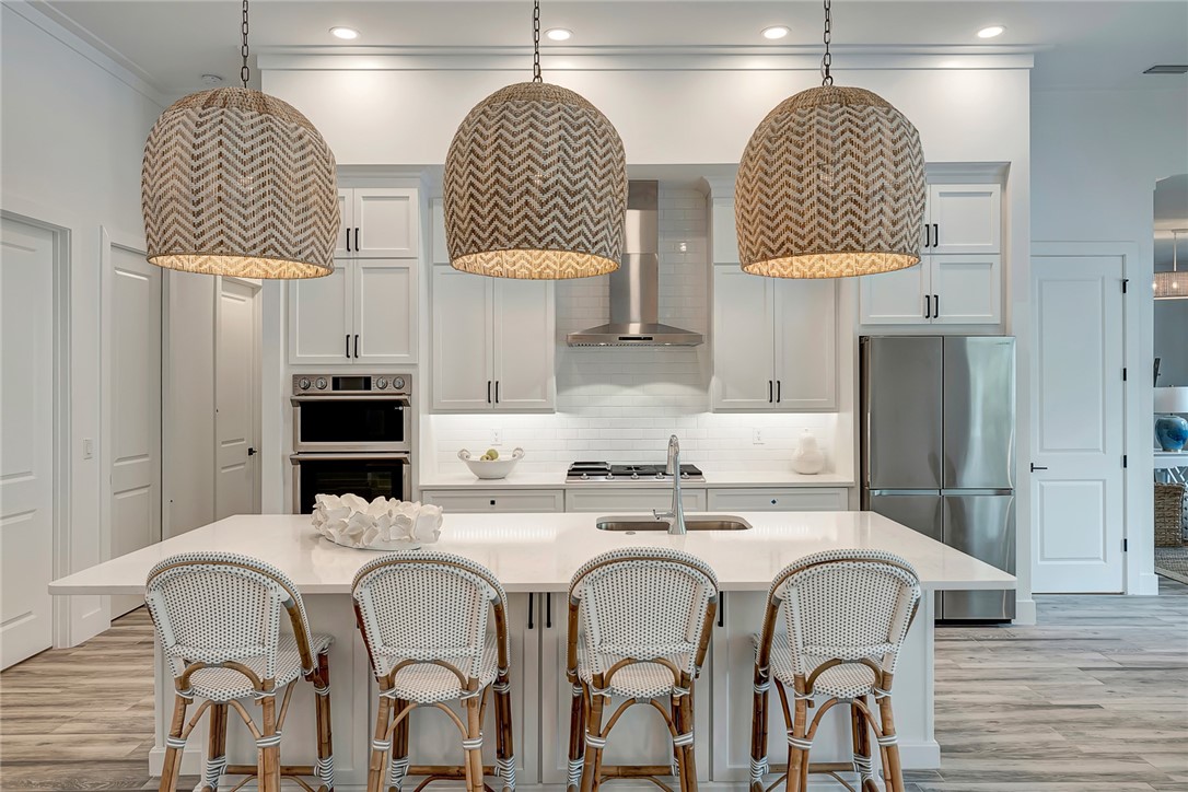 325 Holly Road Vero Beach, FL 32963 - Photo 9 of 25 a kitchen with stainless steel appliances granite countertop a sink and a refrigerator