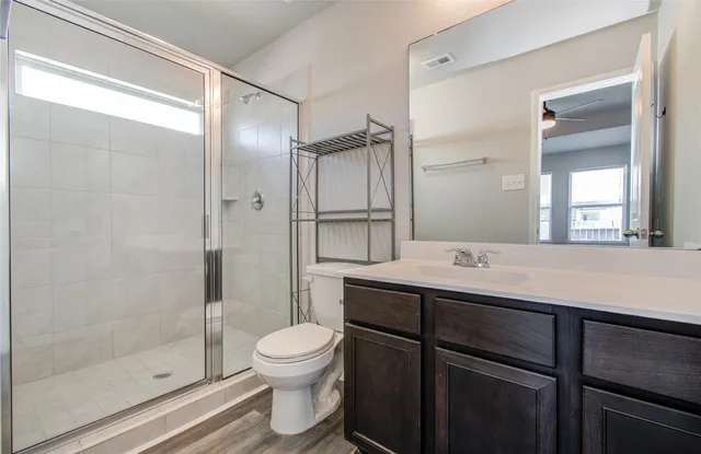 a bathroom with a toilet sink and shower