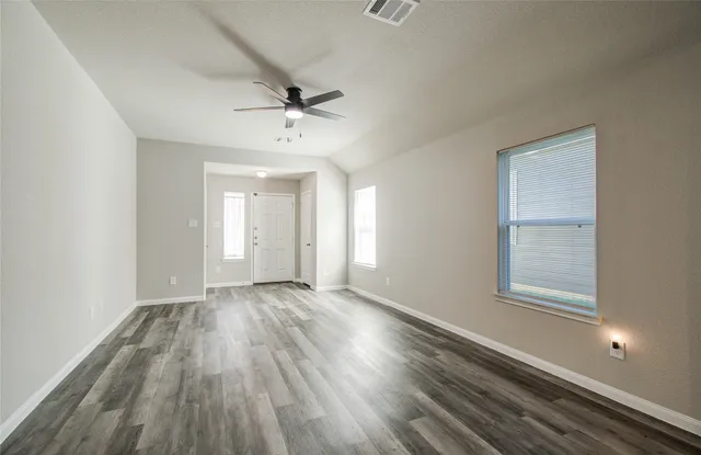wooden floor in an empty room with a window