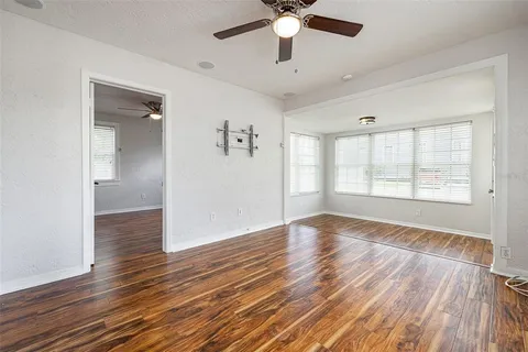 wooden floor in an empty room with a window