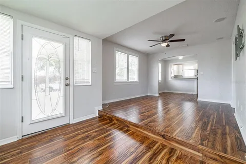 wooden floor in an empty room with a window