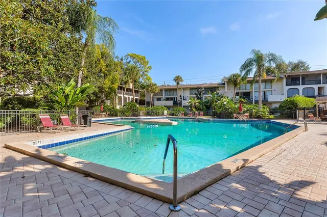 a view of a swimming pool and a yard