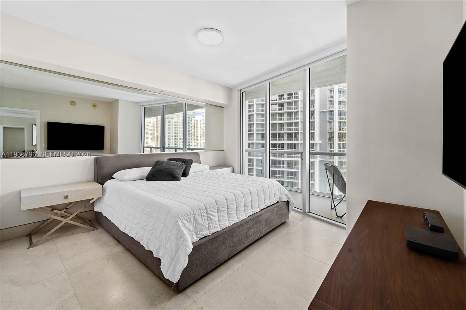 495 Brickell Avenue, Unit 2904 Miami, FL 33131 - Photo 12 of 29 a bed room with a bed window and a television