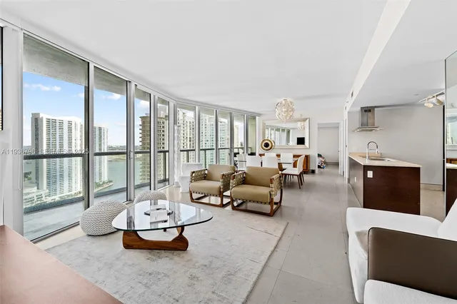 a living room with furniture and a floor to ceiling window