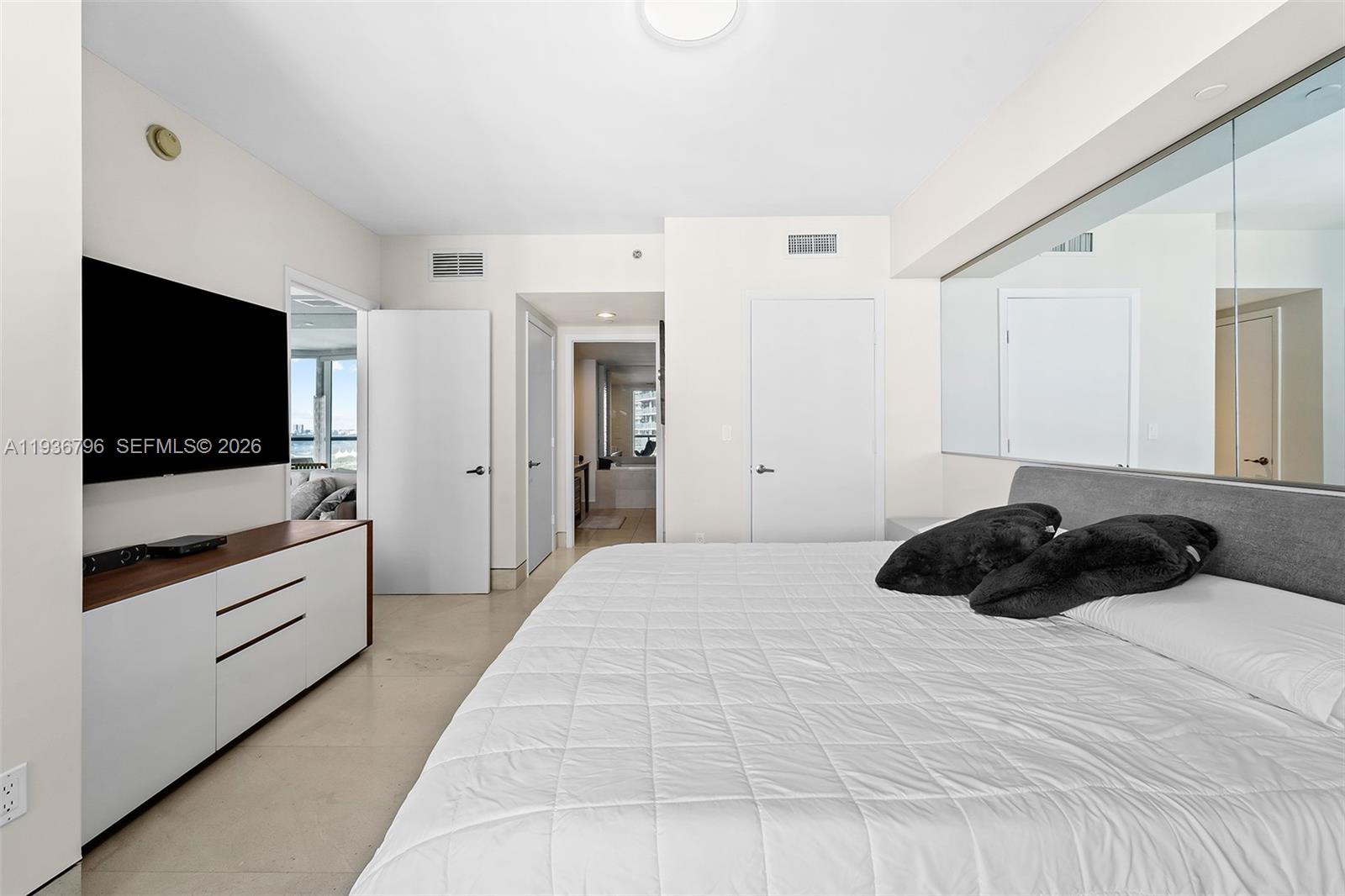 495 Brickell Avenue, Unit 2904 Miami, FL 33131 - Photo 14 of 29 a bedroom with a bed and a flat screen tv