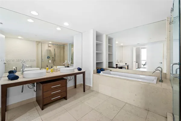 a large bathroom with a double vanity sink and a mirror