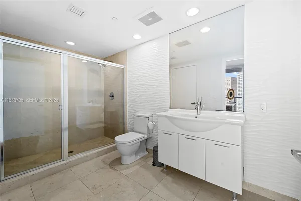 a bathroom with a toilet sink and shower