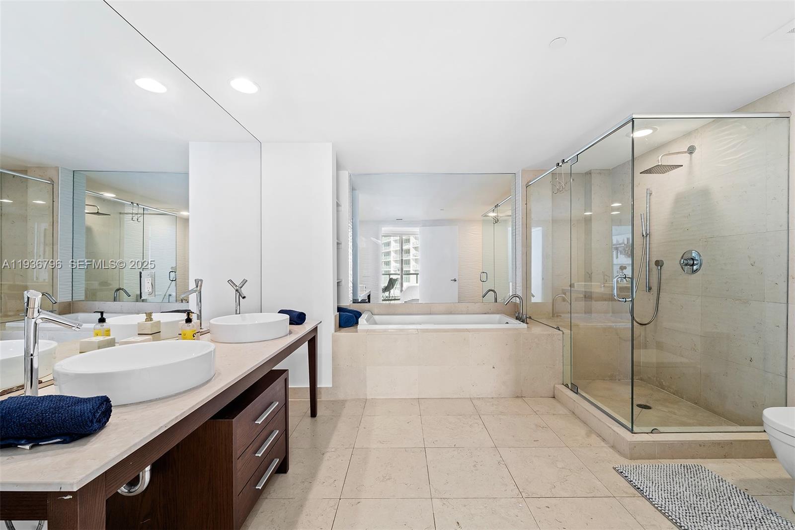 495 Brickell Avenue, Unit 2904 Miami, FL 33131 - Photo 18 of 29 a large bathroom with a double vanity sink and mirror with shower