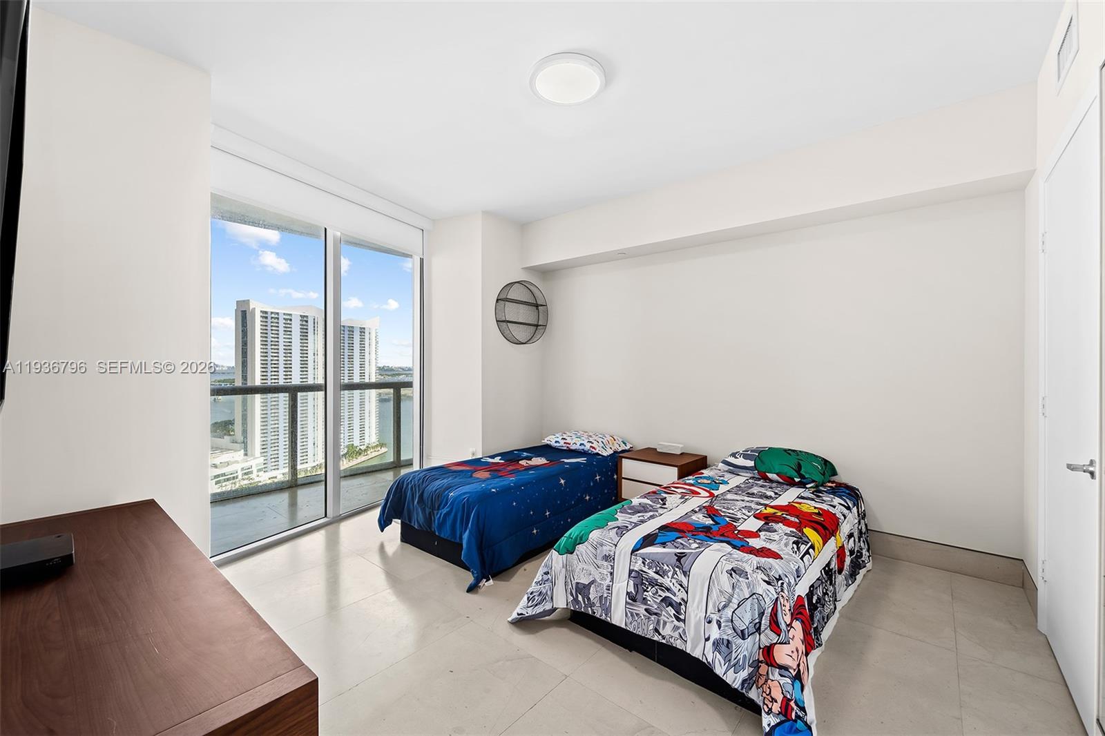 495 Brickell Avenue, Unit 2904 Miami, FL 33131 - Photo 20 of 29 a bedroom with a bed and wooden floor