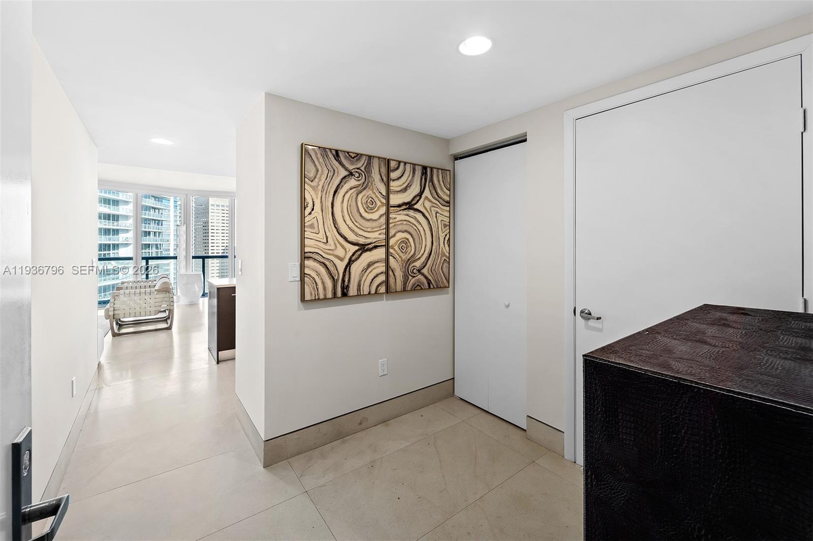 495 Brickell Avenue, Unit 2904 Miami, FL 33131 - Photo 2 of 29 a view of a furniture and an empty room with wooden floor