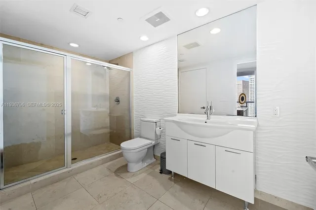 a bathroom with a toilet sink and shower
