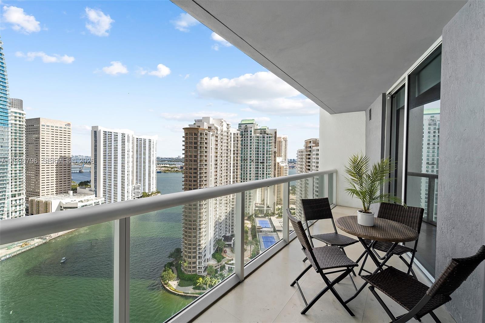 495 Brickell Avenue, Unit 2904 Miami, FL 33131 - Photo 22 of 29 a view of a balcony with furniture and a potted plant