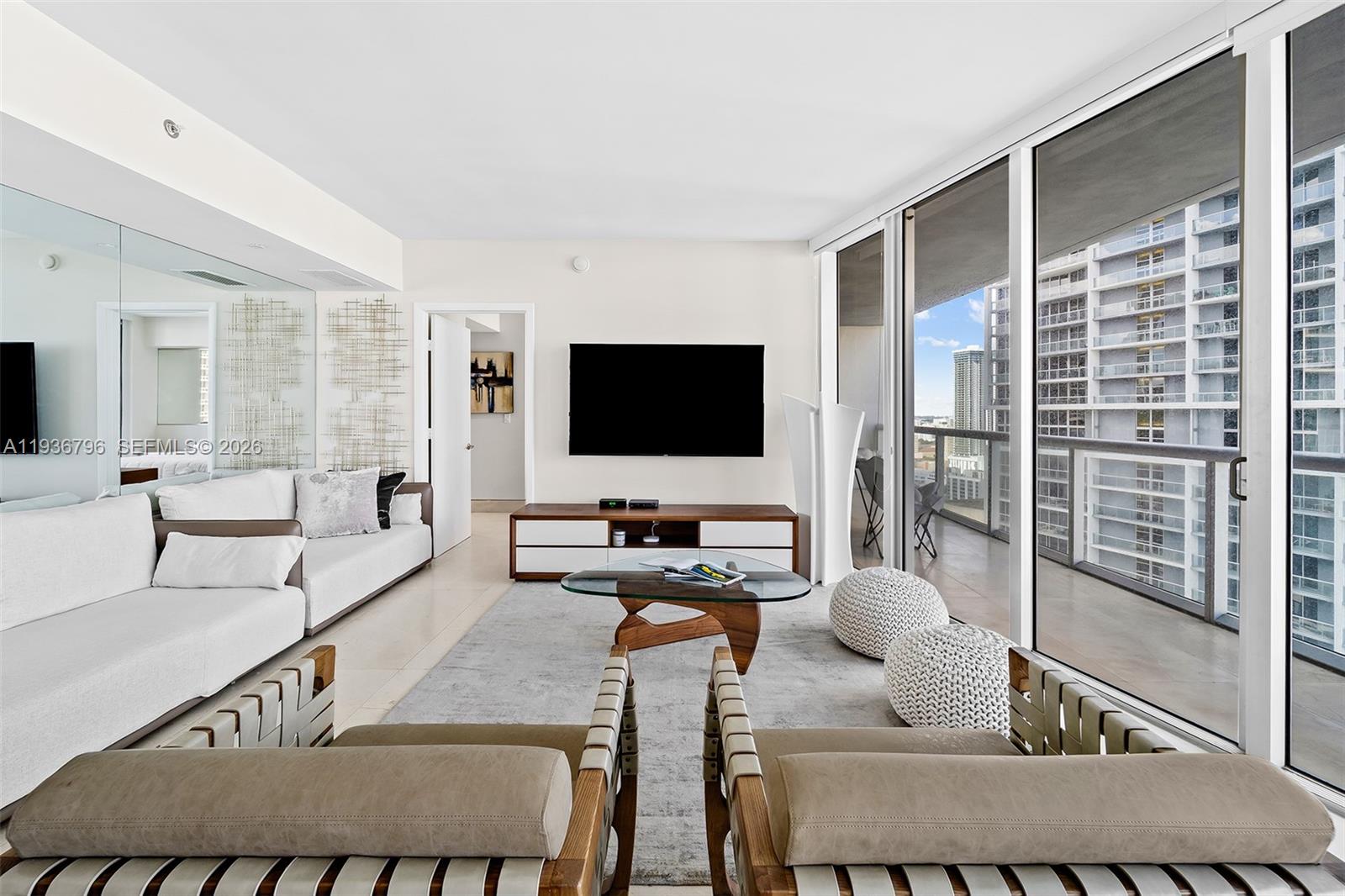 495 Brickell Avenue, Unit 2904 Miami, FL 33131 - Photo 5 of 29 a living room with furniture and a flat screen tv