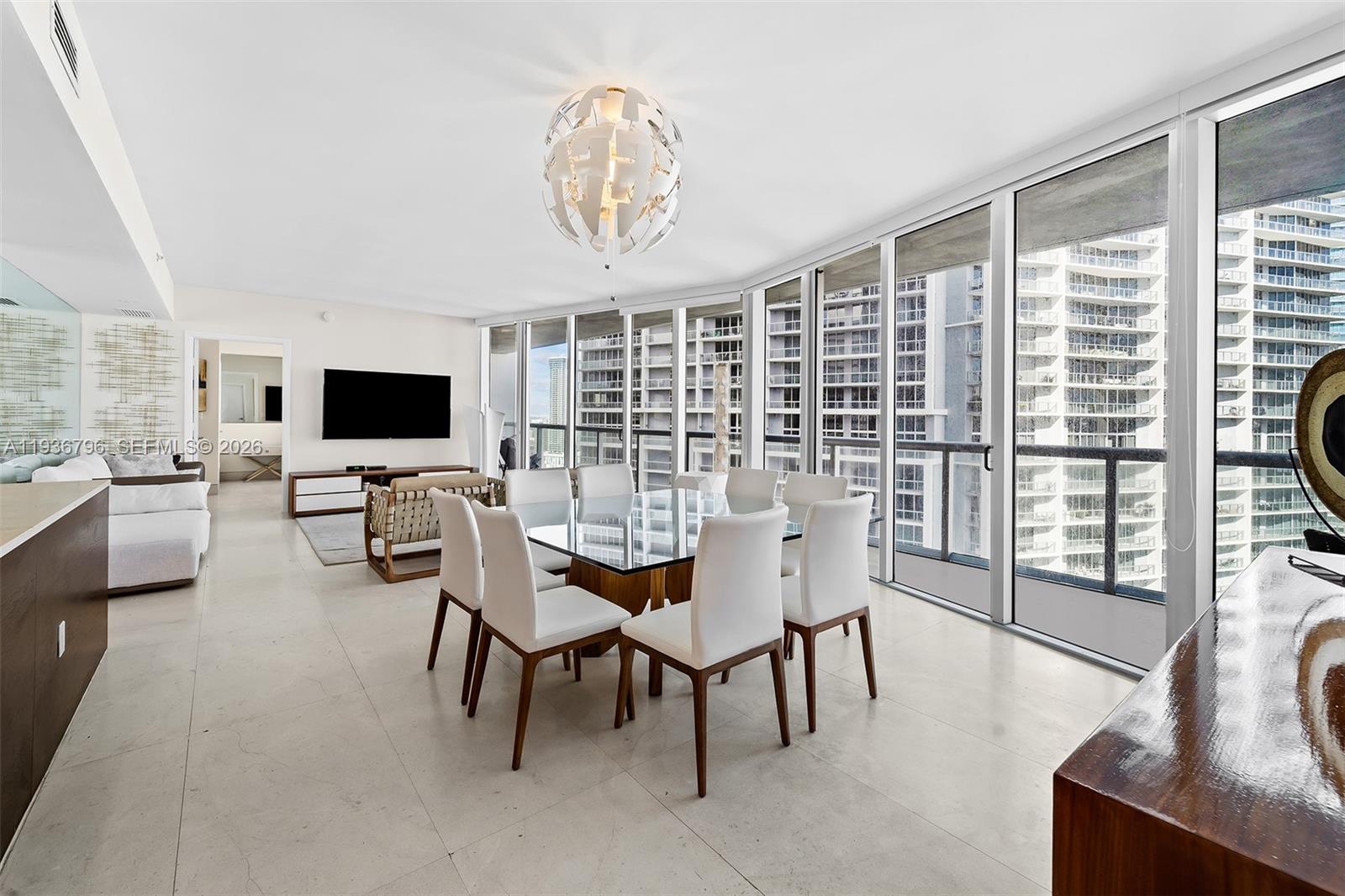 495 Brickell Avenue, Unit 2904 Miami, FL 33131 - Photo 6 of 29 a view of a dining room with furniture window and wooden floor