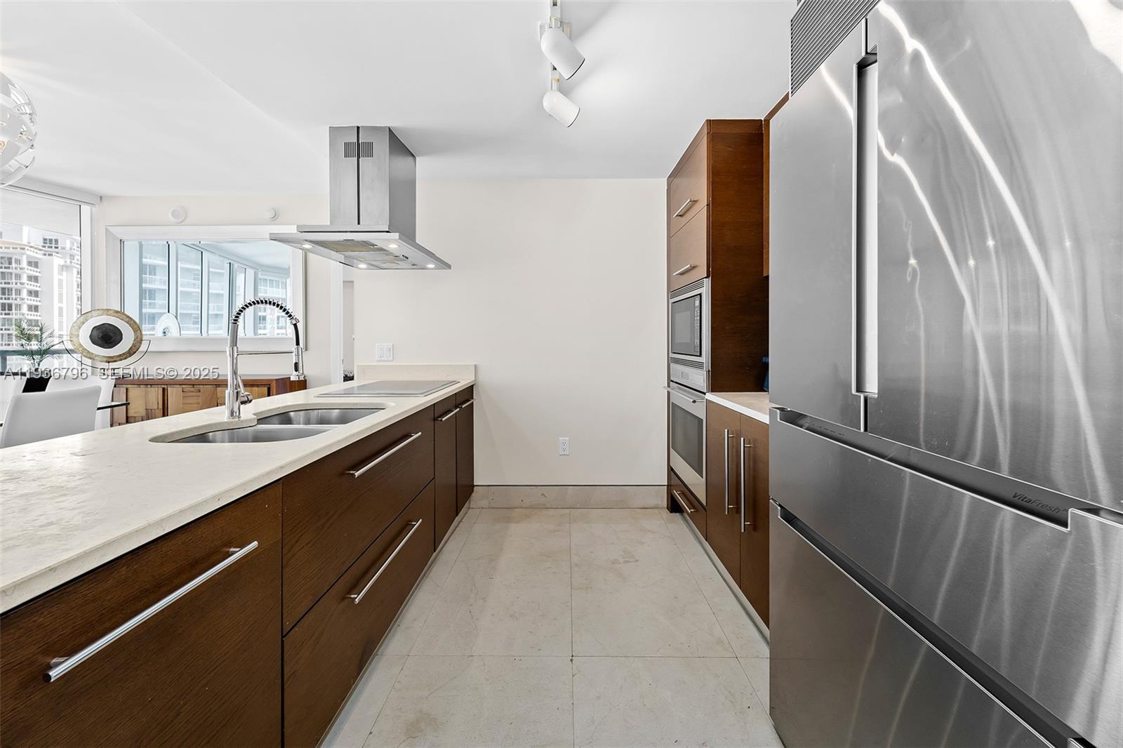 495 Brickell Avenue, Unit 2904 Miami, FL 33131 - Photo 6 of 29 a kitchen with stainless steel appliances a sink and a refrigerator