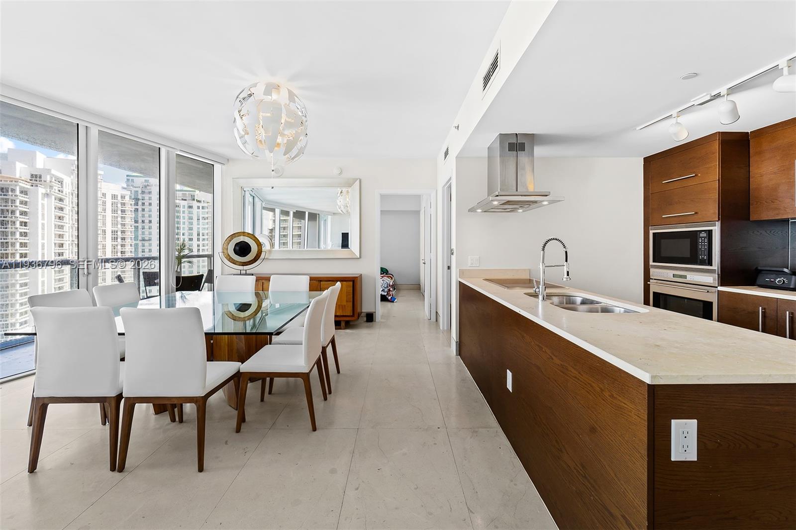 495 Brickell Avenue, Unit 2904 Miami, FL 33131 - Photo 8 of 29 a large kitchen with a table and chairs