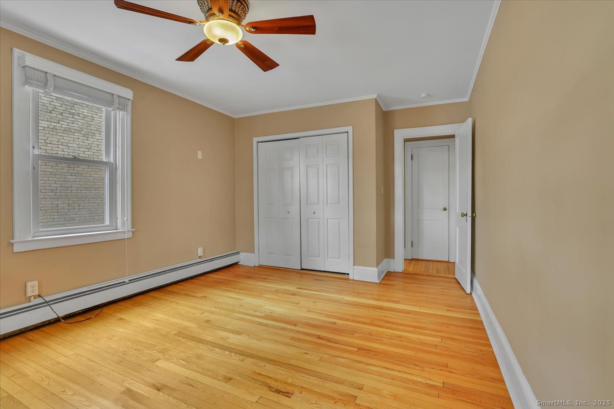 40 Robin Road, Unit 203 West Hartford, CT 06119 - Photo 16 of 22 a view of an empty room with window and wooden floor
