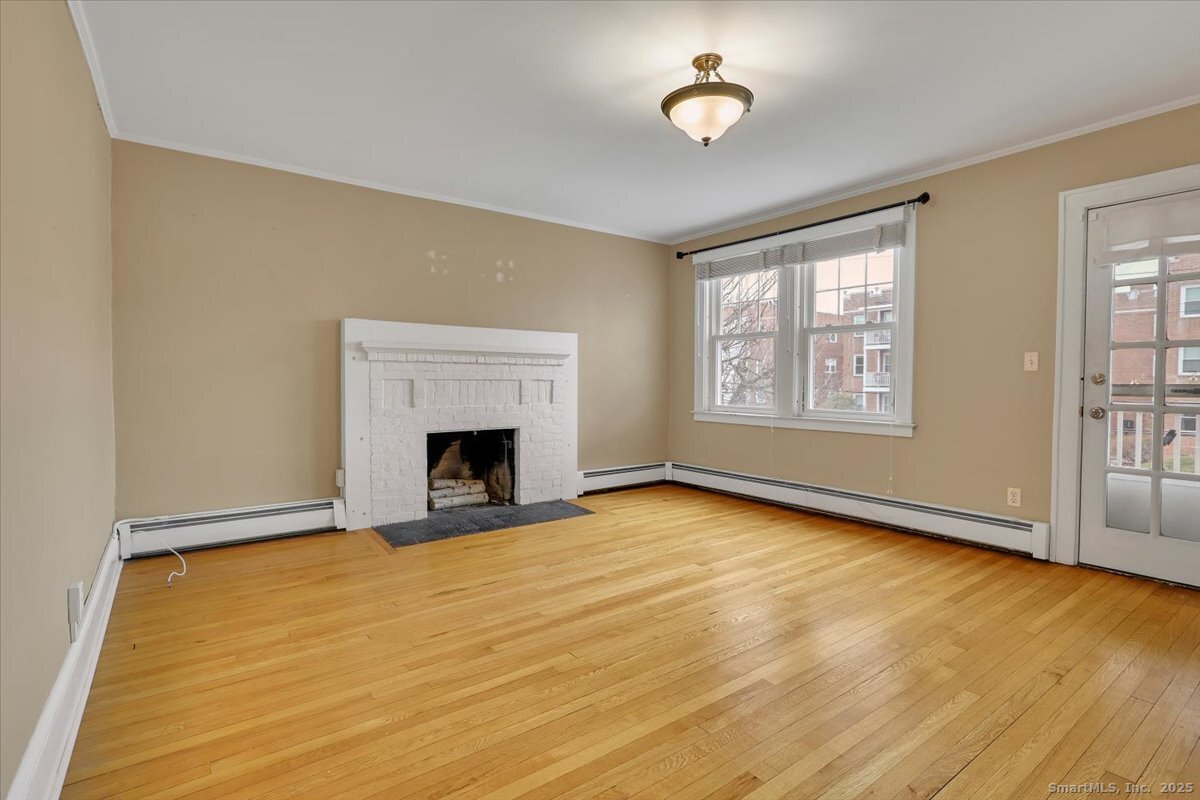 40 Robin Road, Unit 203 West Hartford, CT 06119 - Photo 5 of 22 a view of an empty room with a window and fireplace