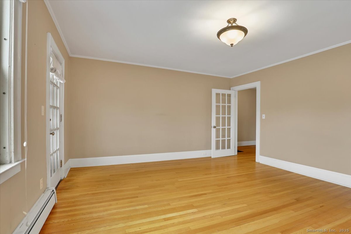 40 Robin Road, Unit 203 West Hartford, CT 06119 - Photo 6 of 22 a view of an empty room with wooden floor