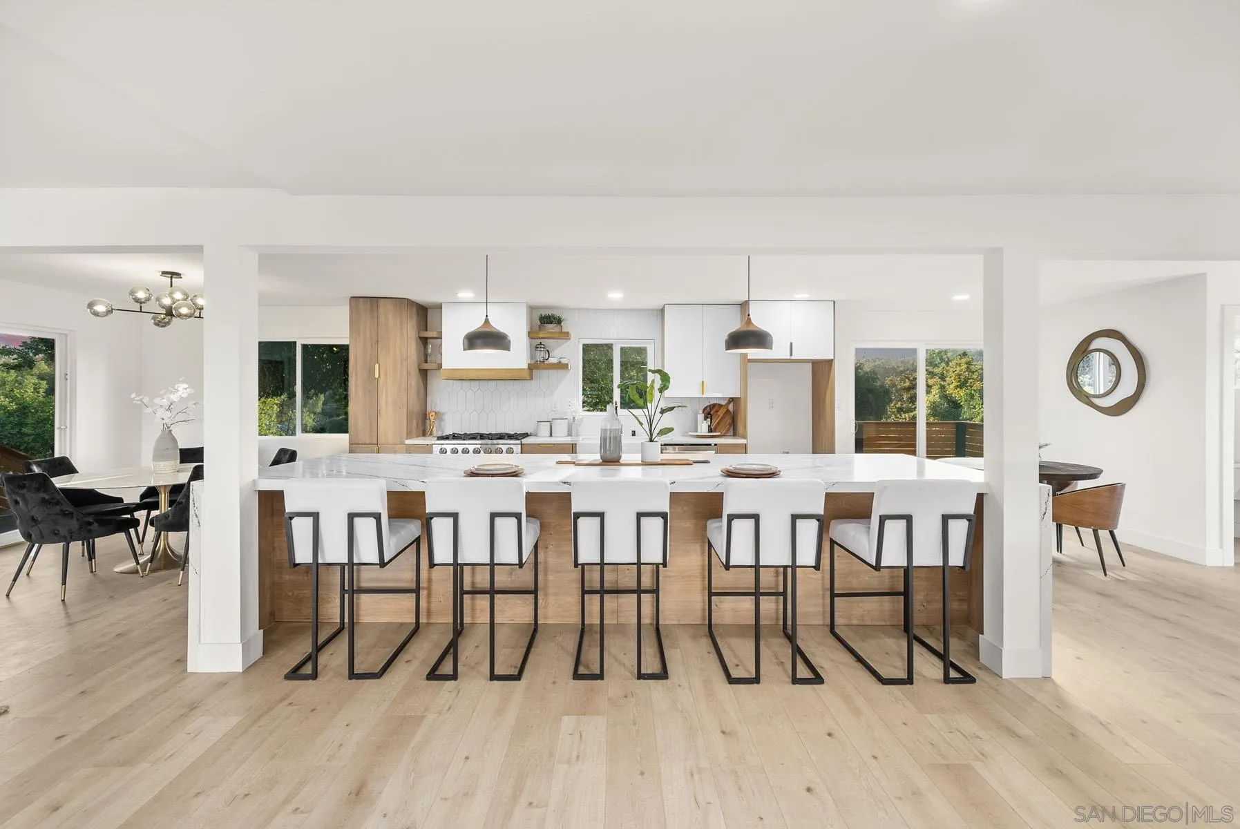 11442 Pinehurst Drive Lakeside, CA 92040 - Photo 16 of 46 a dining hall with stainless steel appliances a dining table chairs and couches with wooden floor