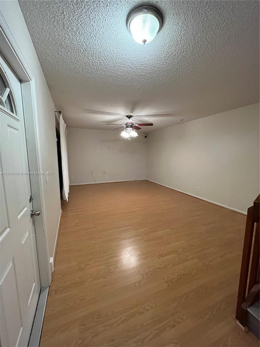 7657 Courtyard Run West, Unit 7657 Boca Raton, FL 33433 - Photo 12 of 36 wooden floor in an empty room with a window
