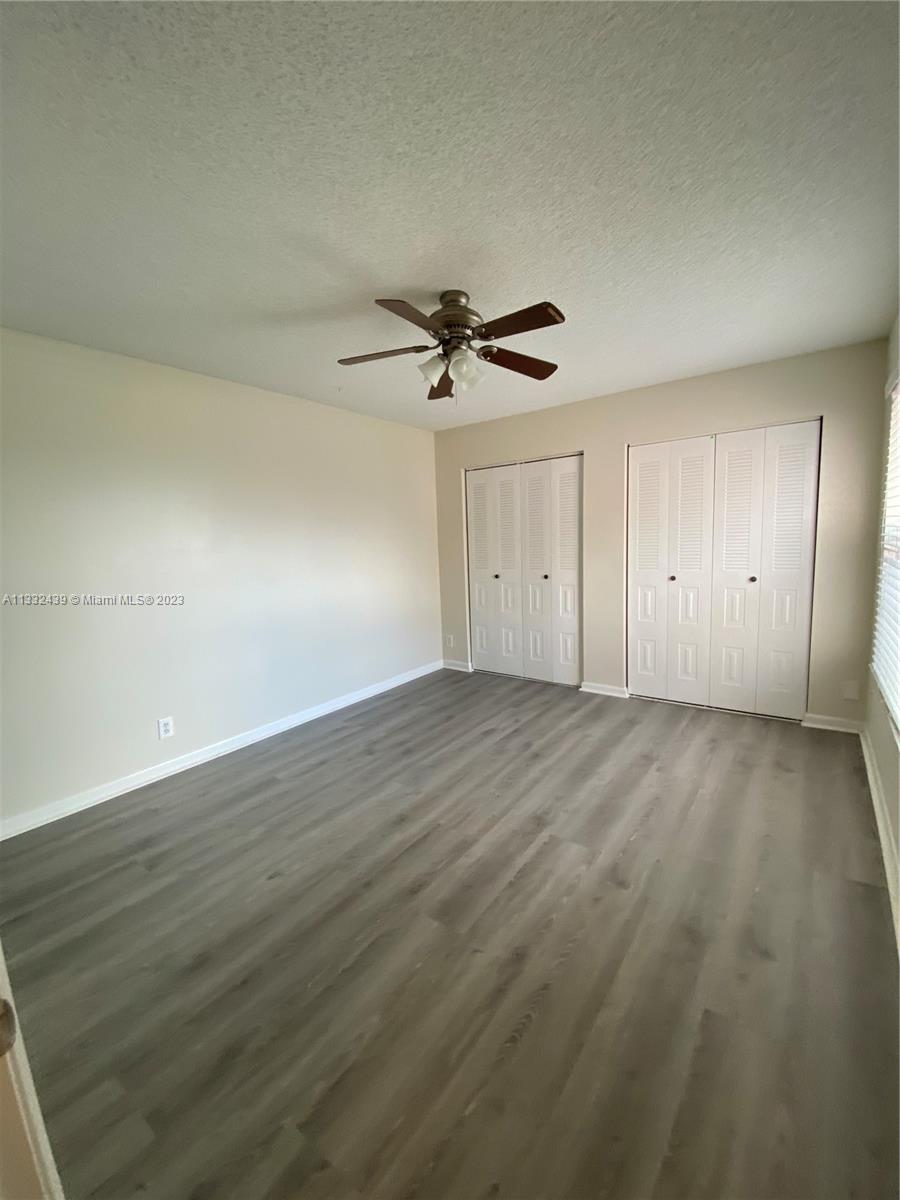 7657 Courtyard Run West, Unit 7657 Boca Raton, FL 33433 - Photo 26 of 36 wooden floor in an empty room