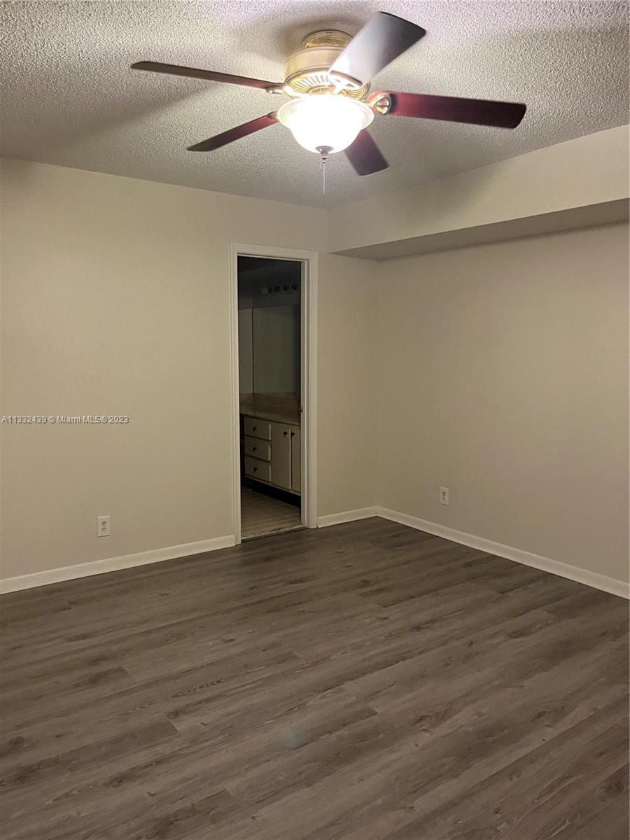 7657 Courtyard Run West, Unit 7657 Boca Raton, FL 33433 - Photo 27 of 36 a view of empty room with wooden floor and fan