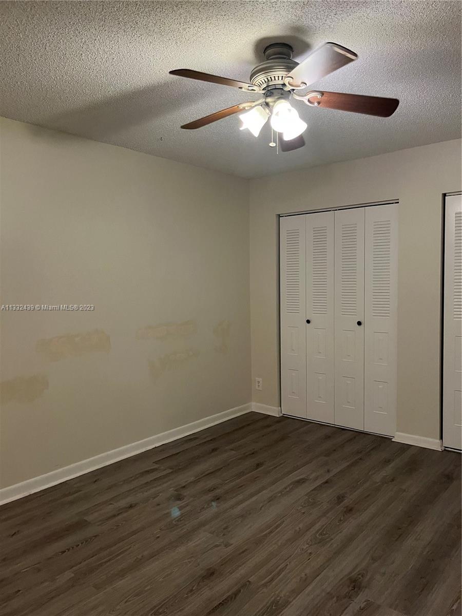 7657 Courtyard Run West, Unit 7657 Boca Raton, FL 33433 - Photo 28 of 36 a view of an empty room with wooden floor