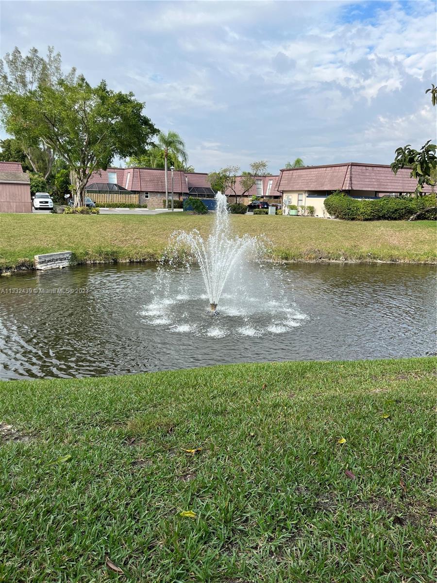 7657 Courtyard Run West, Unit 7657 Boca Raton, FL 33433 - Photo 4 of 36 a view of a lake with houses in the back