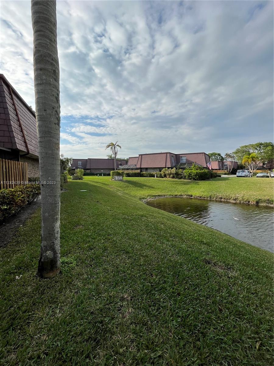 7657 Courtyard Run West, Unit 7657 Boca Raton, FL 33433 - Photo 5 of 36 a view of a golf course with a lake