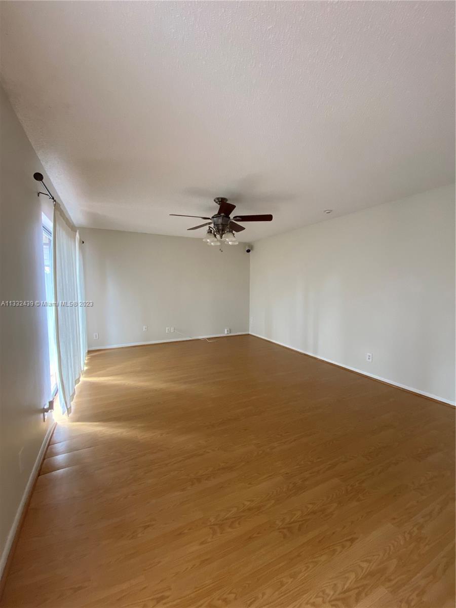 7657 Courtyard Run West, Unit 7657 Boca Raton, FL 33433 - Photo 7 of 36 an empty room with a empty space and a ceiling fan