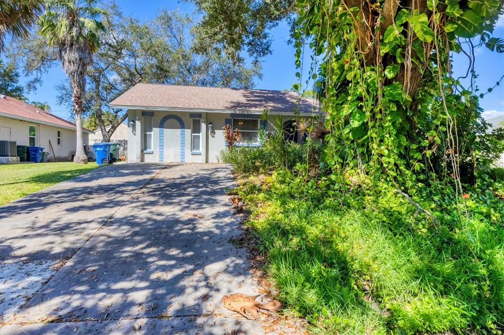 280 Drake Road Venice, FL 34293 - Photo 1 of 1 a front view of a house with a yard fountain and outdoor seating