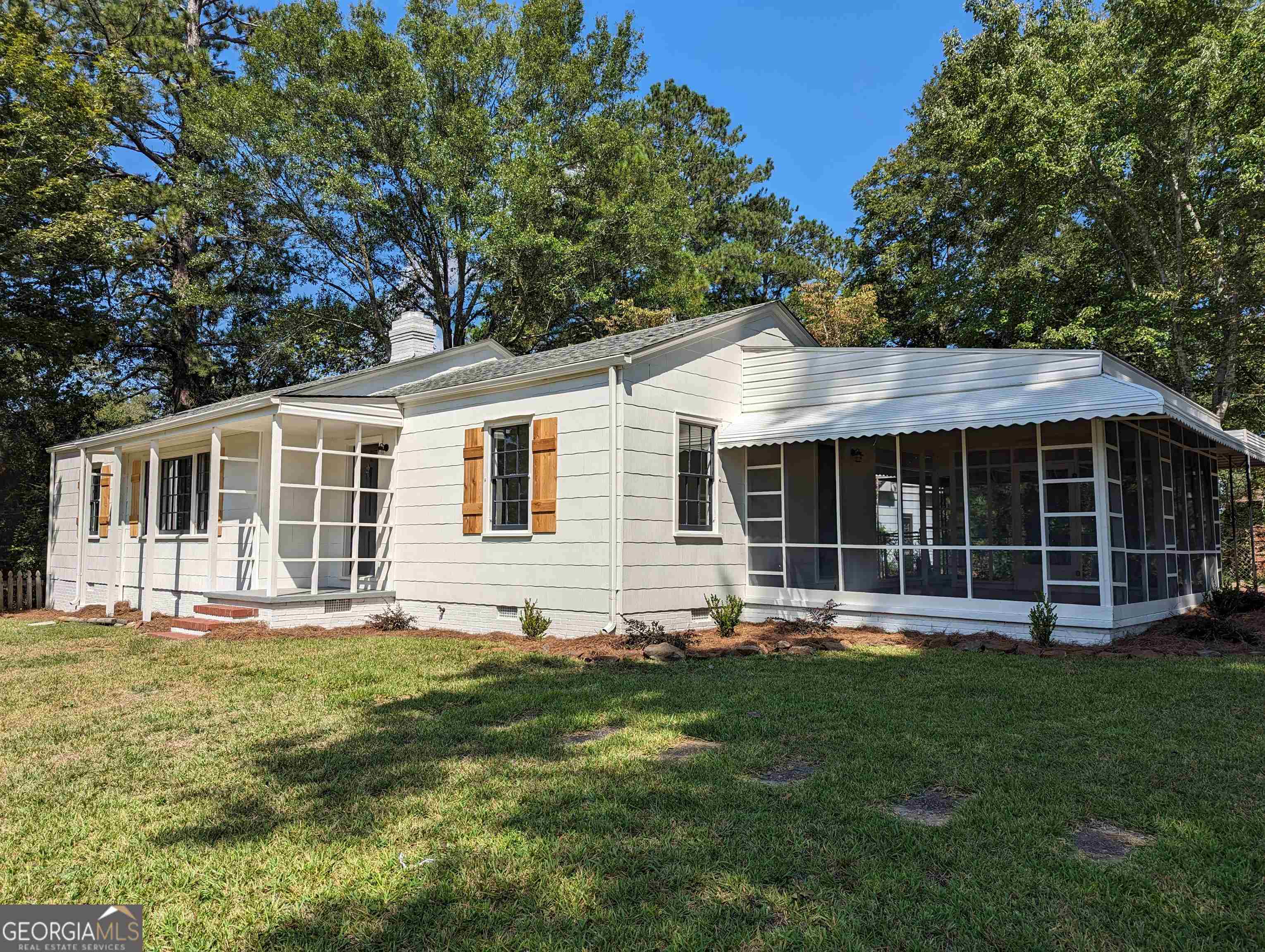a front view of house with yard and green space