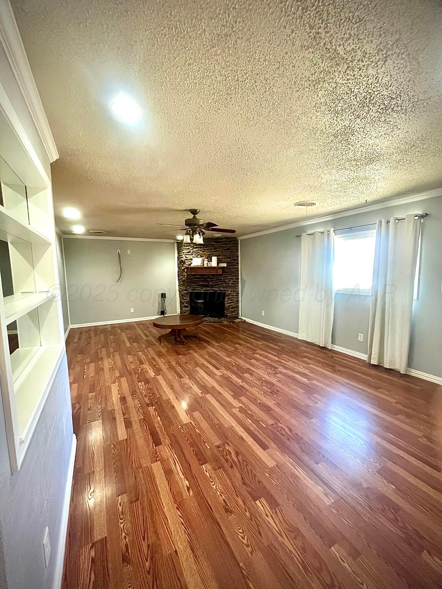 5116 Crockett Street Amarillo, TX 79110 - Photo 4 of 23 a view of empty room with wooden floor