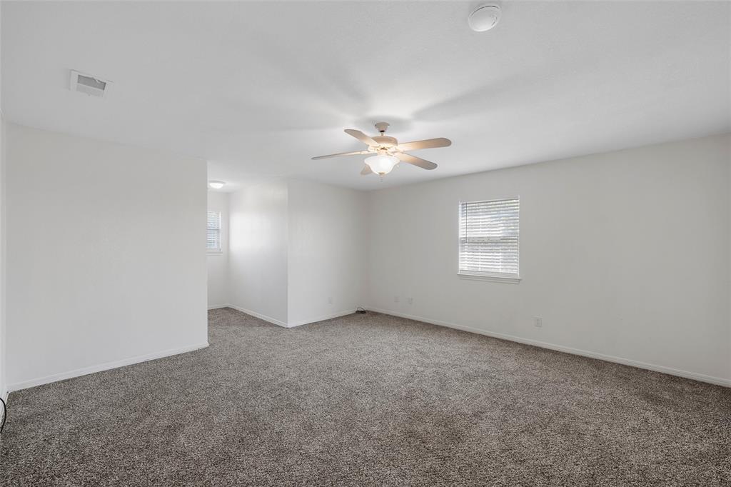 5112 Old Caufield Ranch Road McGregor, TX 76657 - Photo 24 of 38 Spare room with light carpet and ceiling fan