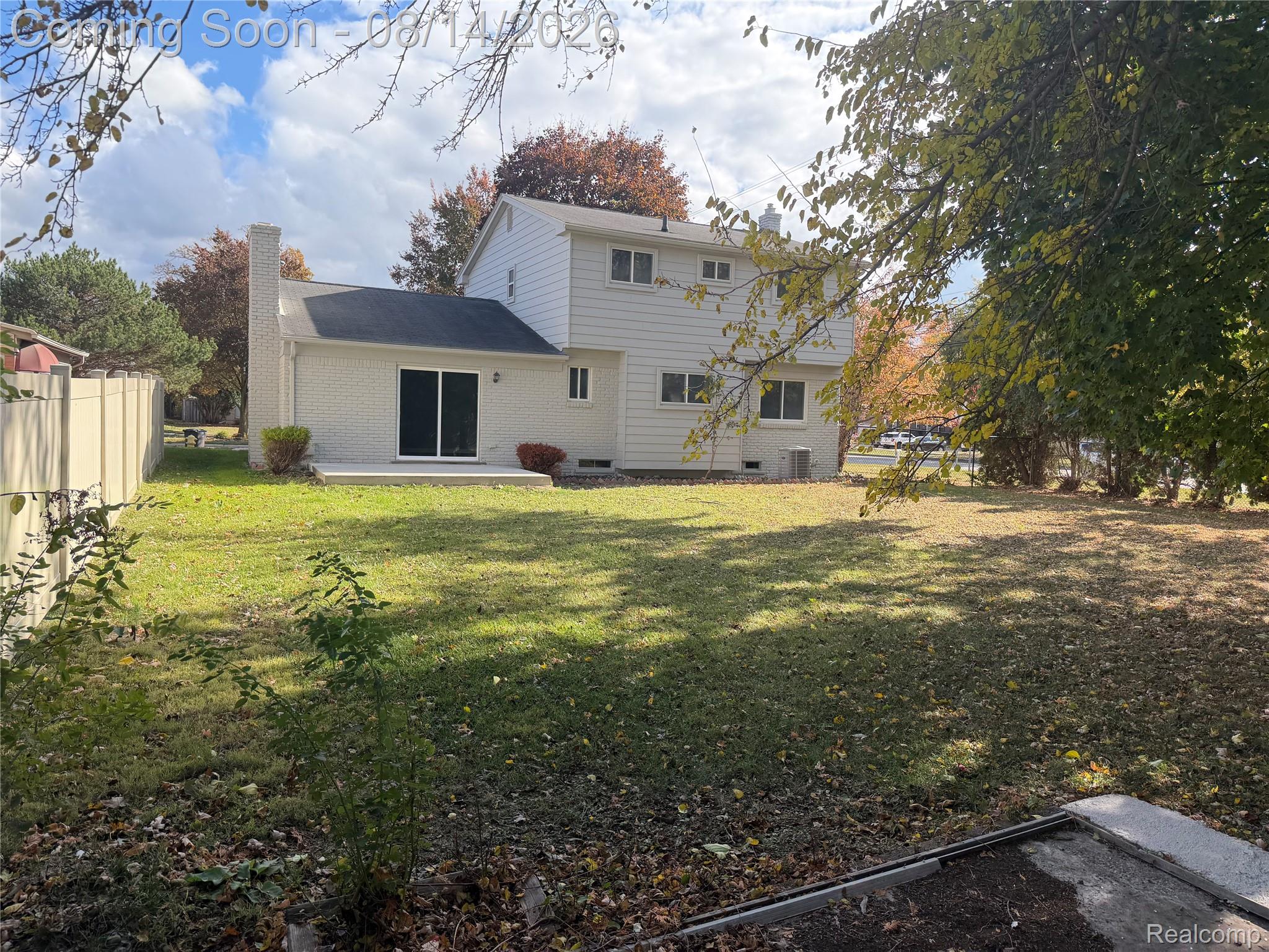 20698 Coachwood Road Riverview, MI 48193 - Photo 36 of 37 Expansive rear yard featuring a manicured lawn, established trees, and a concrete patio