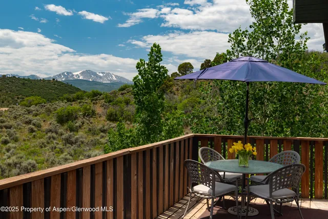 a view of a chair and table on the roof deck