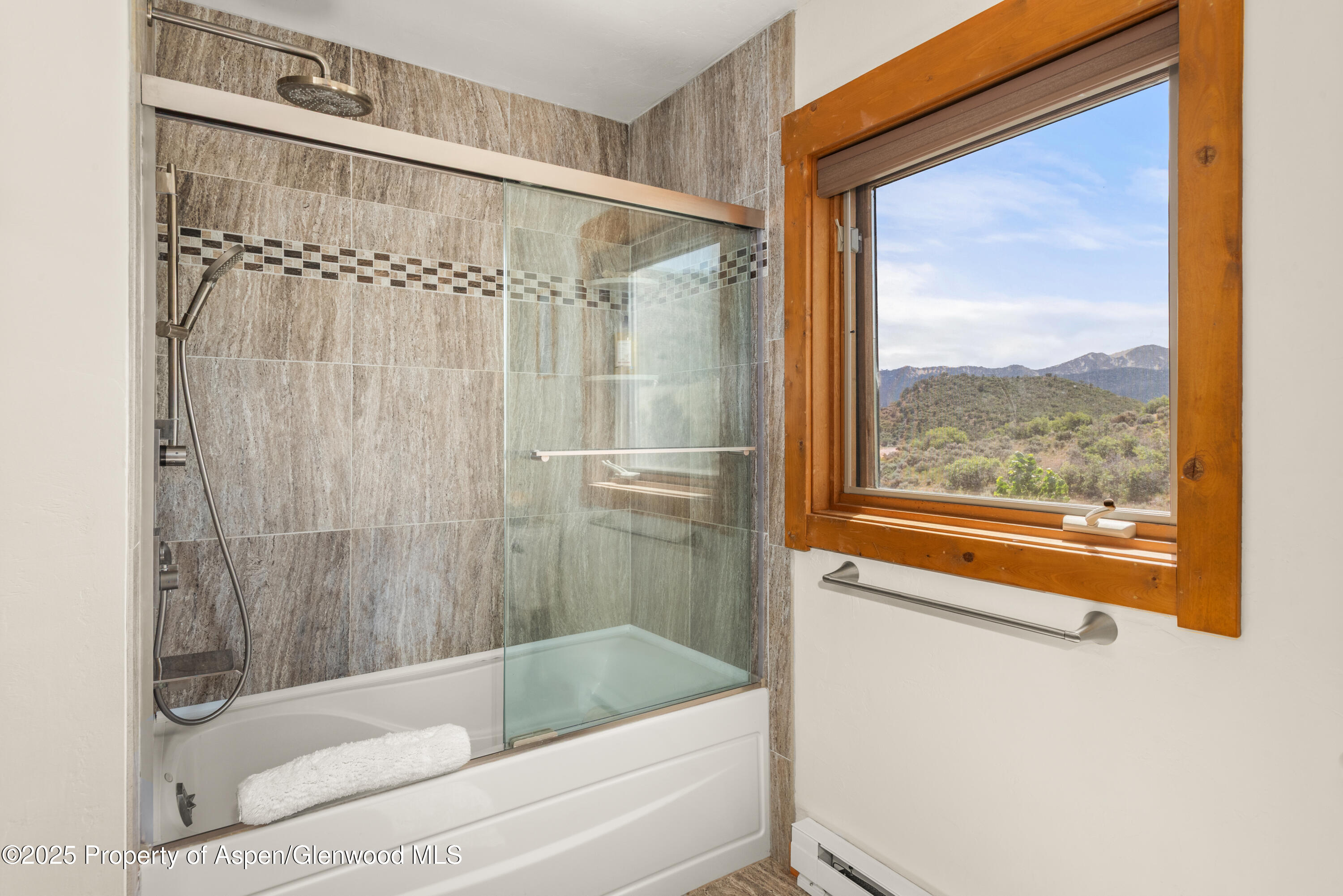 614 Light Hill Road Snowmass, CO 81654 - Photo 11 of 22 a bathroom with a bathtub and a shower