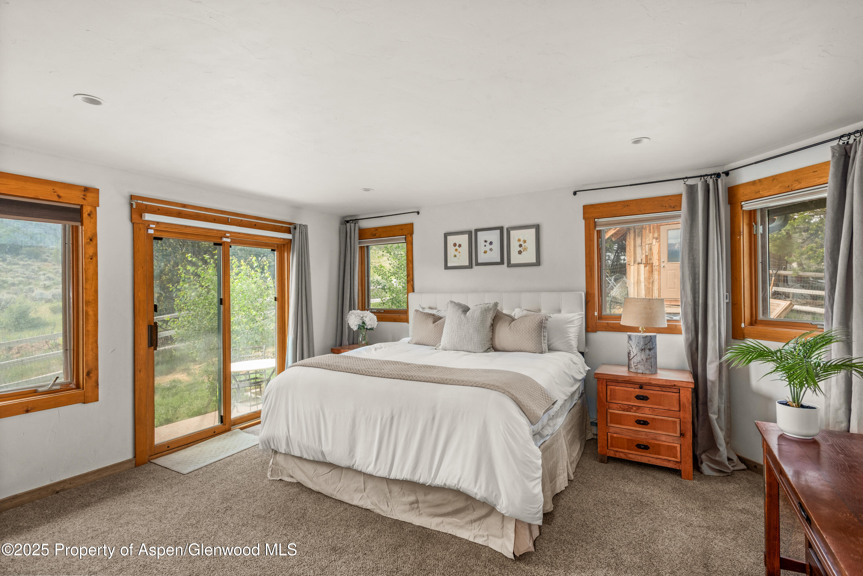614 Light Hill Road Snowmass, CO 81654 - Photo 12 of 22 a bedroom with a large bed and a large window