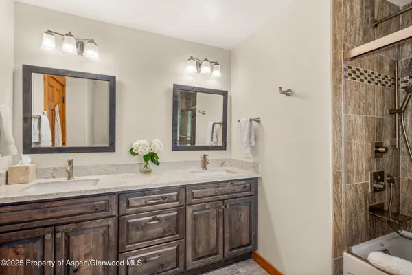 a bathroom with a double vanity sink and a mirror