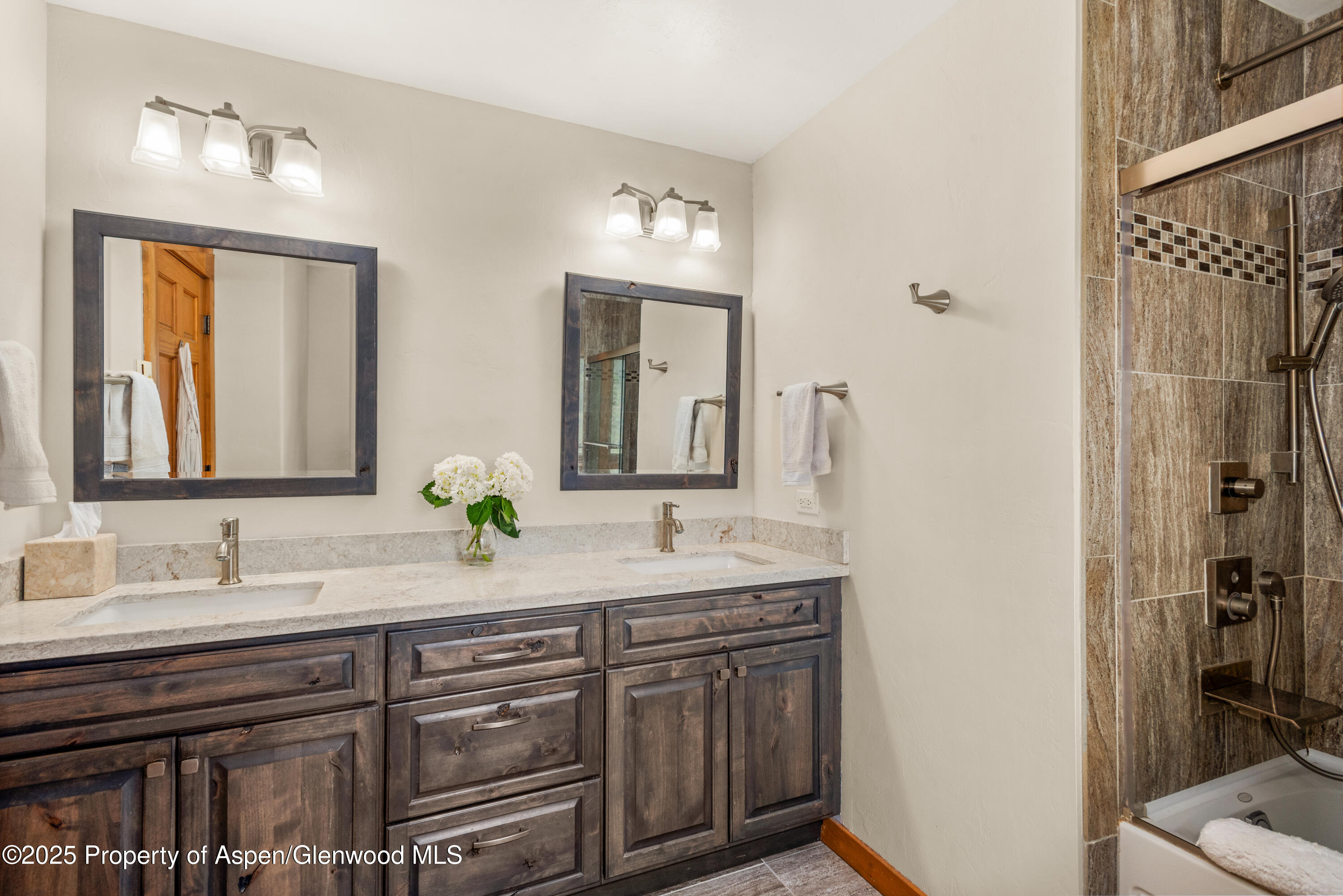 614 Light Hill Road Snowmass, CO 81654 - Photo 10 of 22 a bathroom with a double vanity sink and a mirror