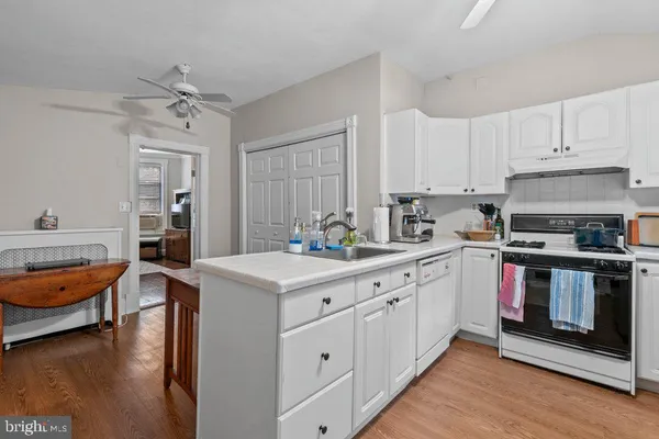a kitchen with stainless steel appliances a stove a sink and a refrigerator
