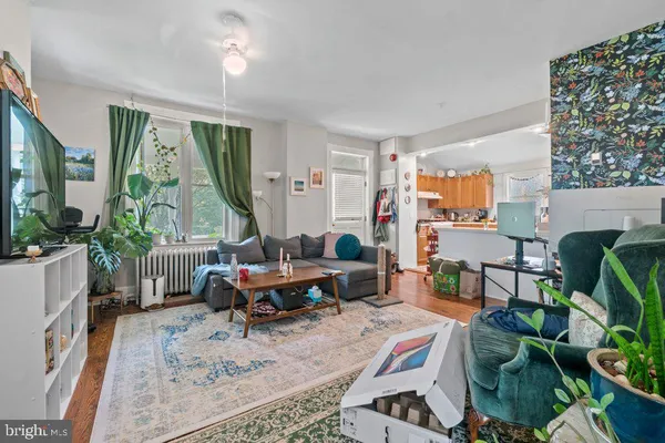 a living room with furniture a large window and a table