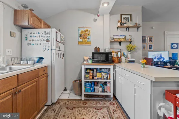 a bedroom with furniture a rug and a window